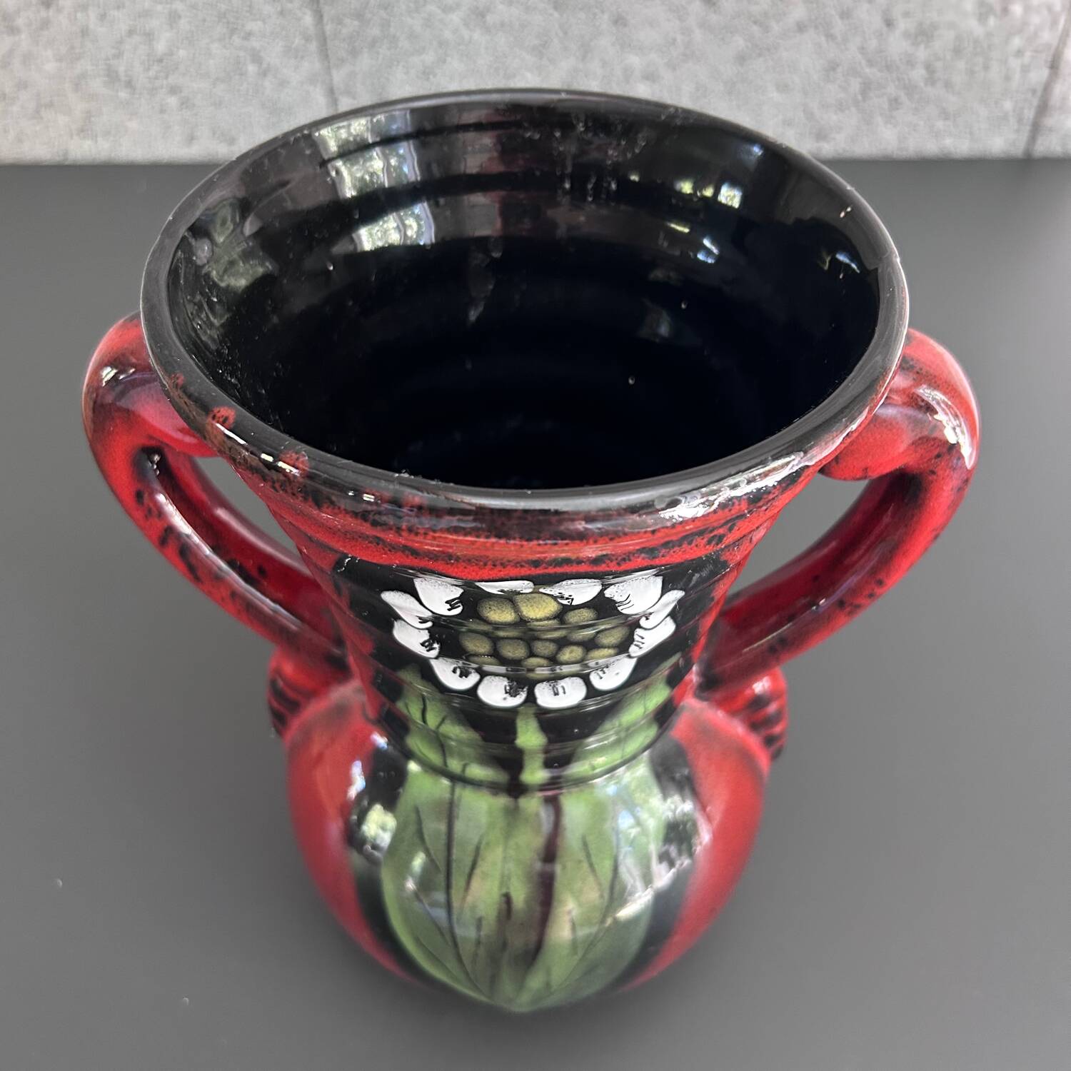 Red vase with floral decoration