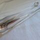 Christofle Silver-plated metal sugar tongs with crossed ribbon bow design