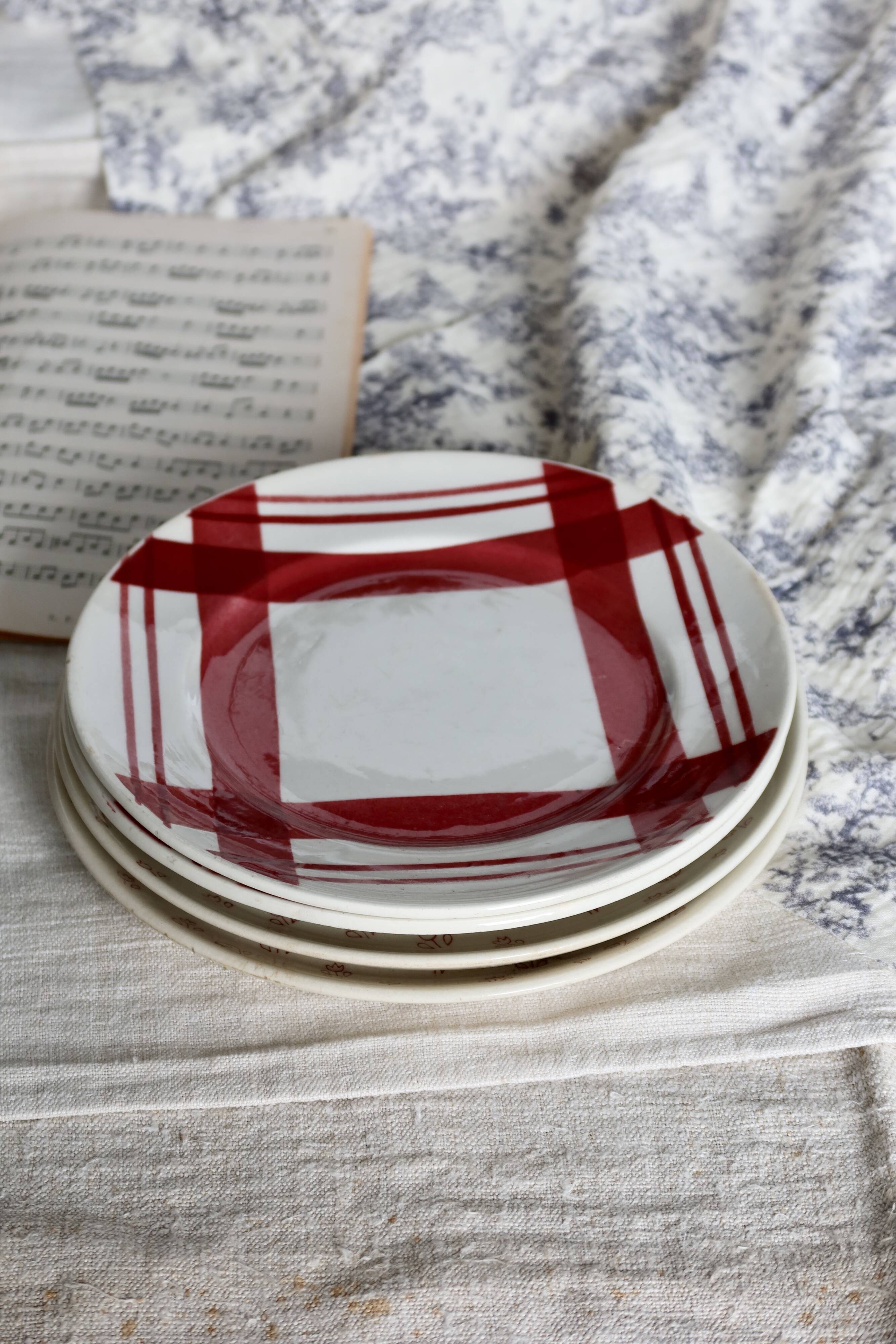 Vintage mismatched earthenware dessert plates with red patterns