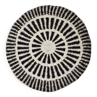Round wool cushion with white patterns