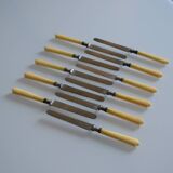 11 antique 19th-century table knives with ivory-colored monogram handles