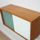 A vintage mid-century wall hung oak cabinet, green & white glass doors