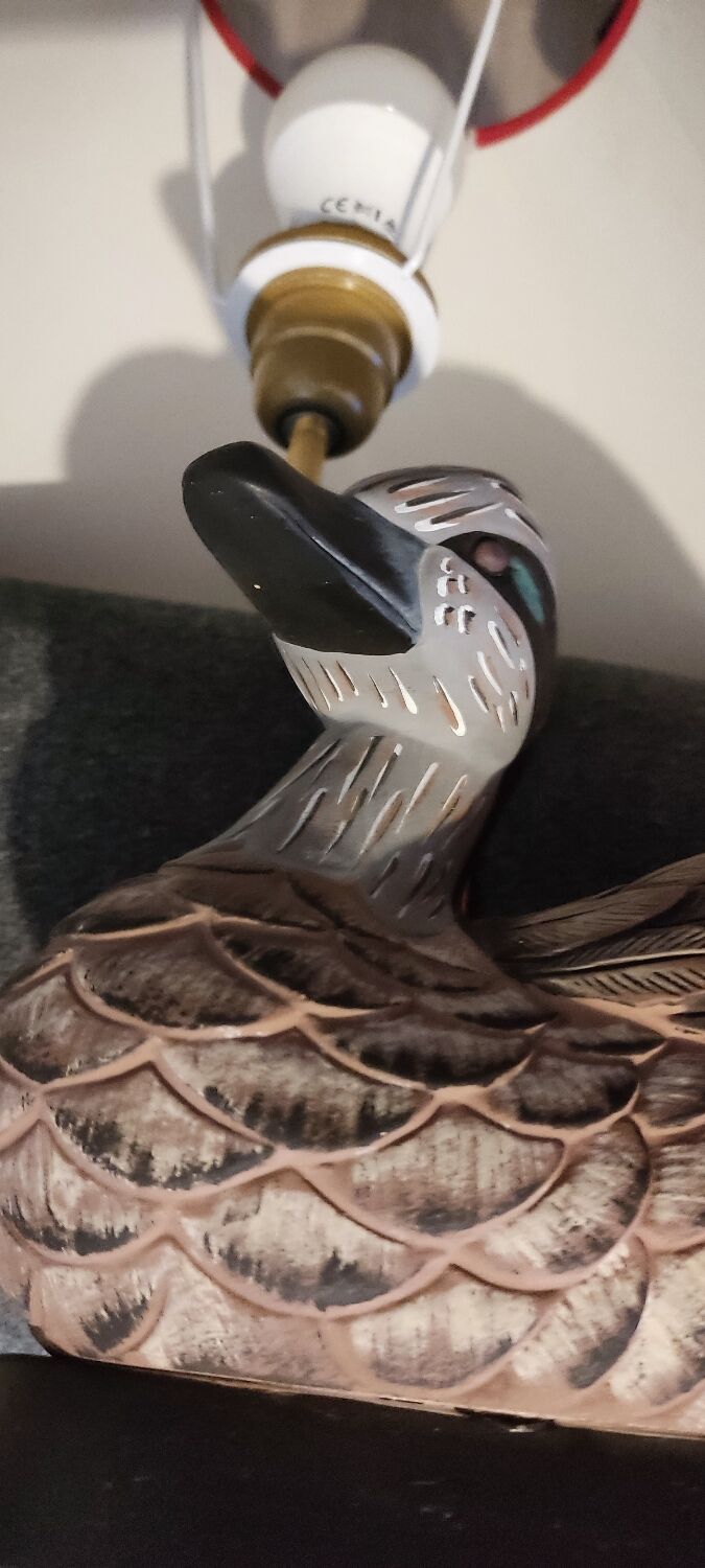 Decorative table lamp with a sculpted duck-shaped base and painted finish.