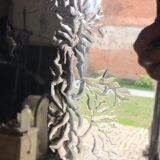 Venetian mirror topped with half a chandelier of Murano