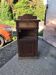 Rustic brown pine bedside table with drawer, door, and shelf — early 20th century
