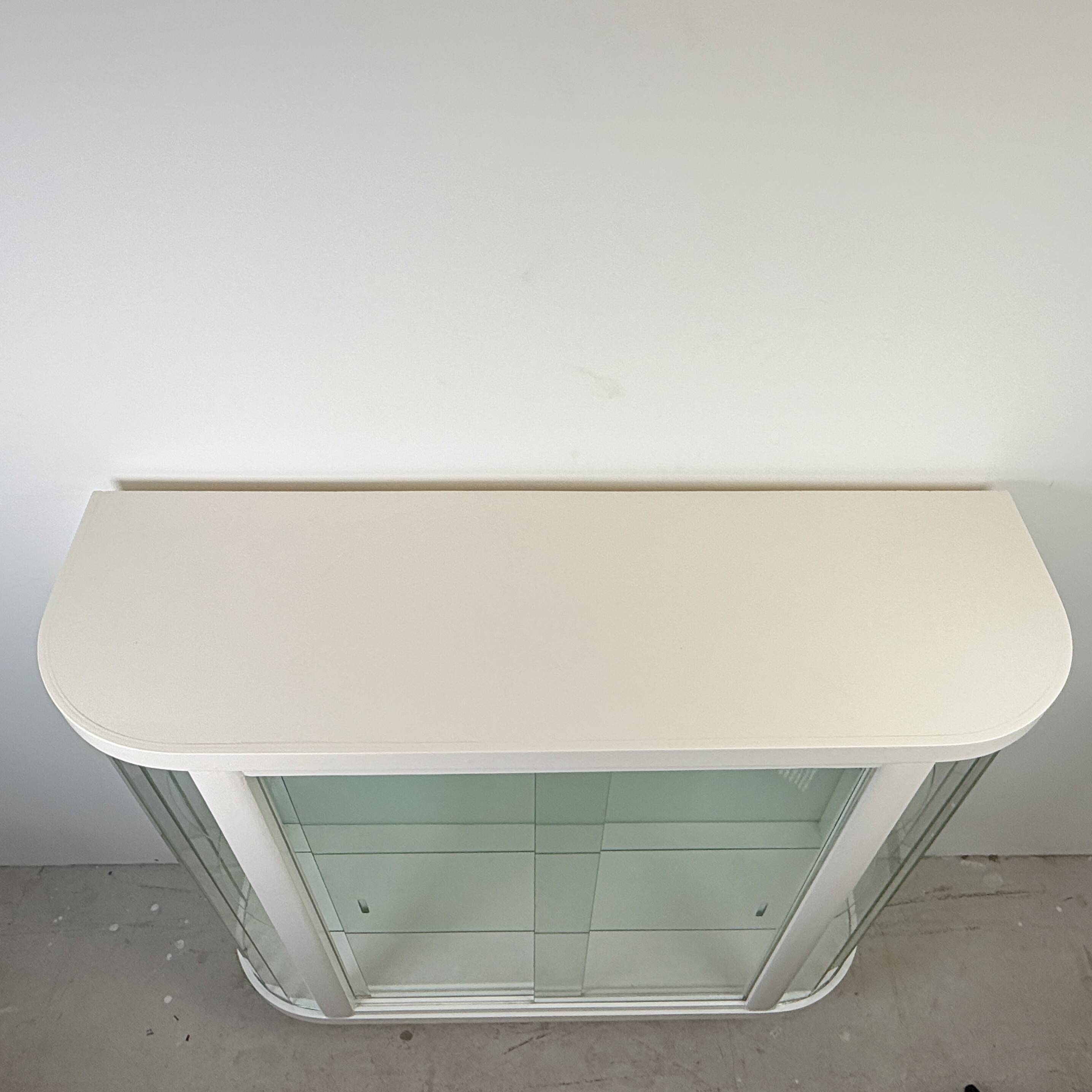 White vintage slatted display case on gold legs