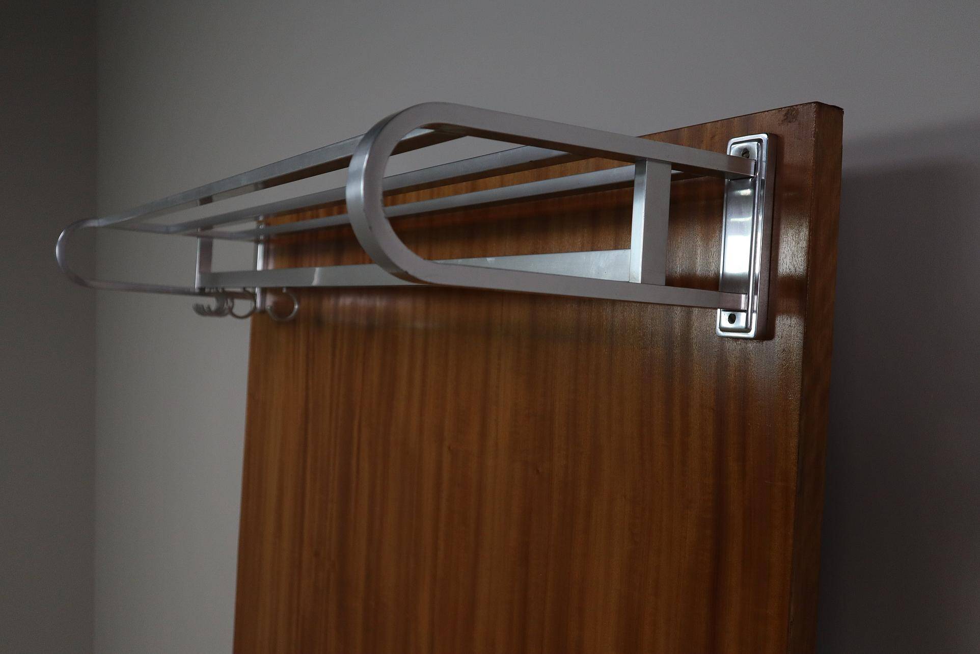Modernist wall-mounted cloakroom in teak
