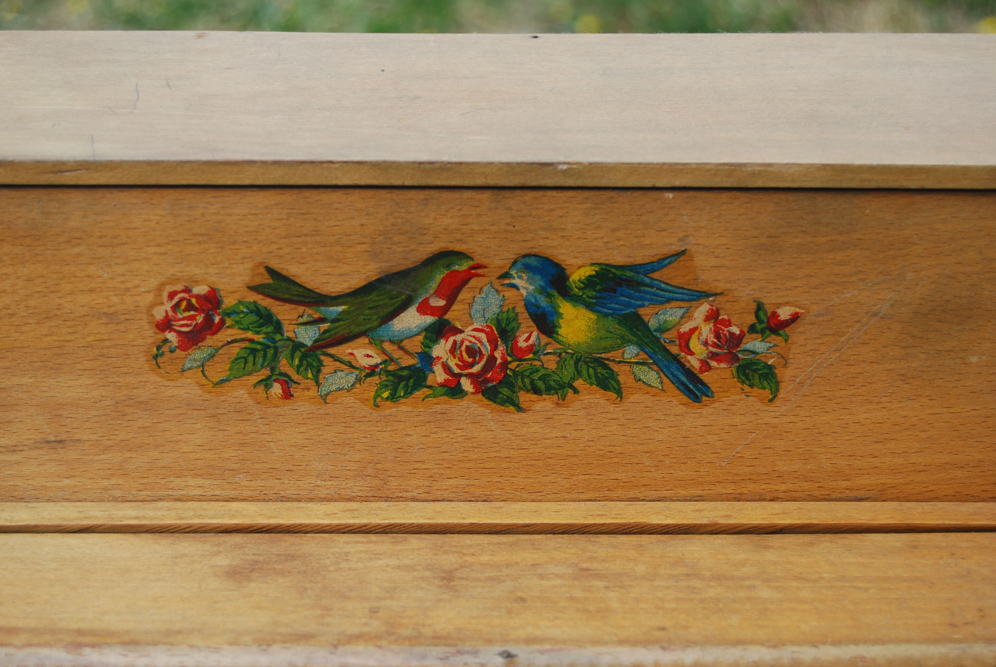 Ancient toy, wooden piano, decorating birds on rose bush