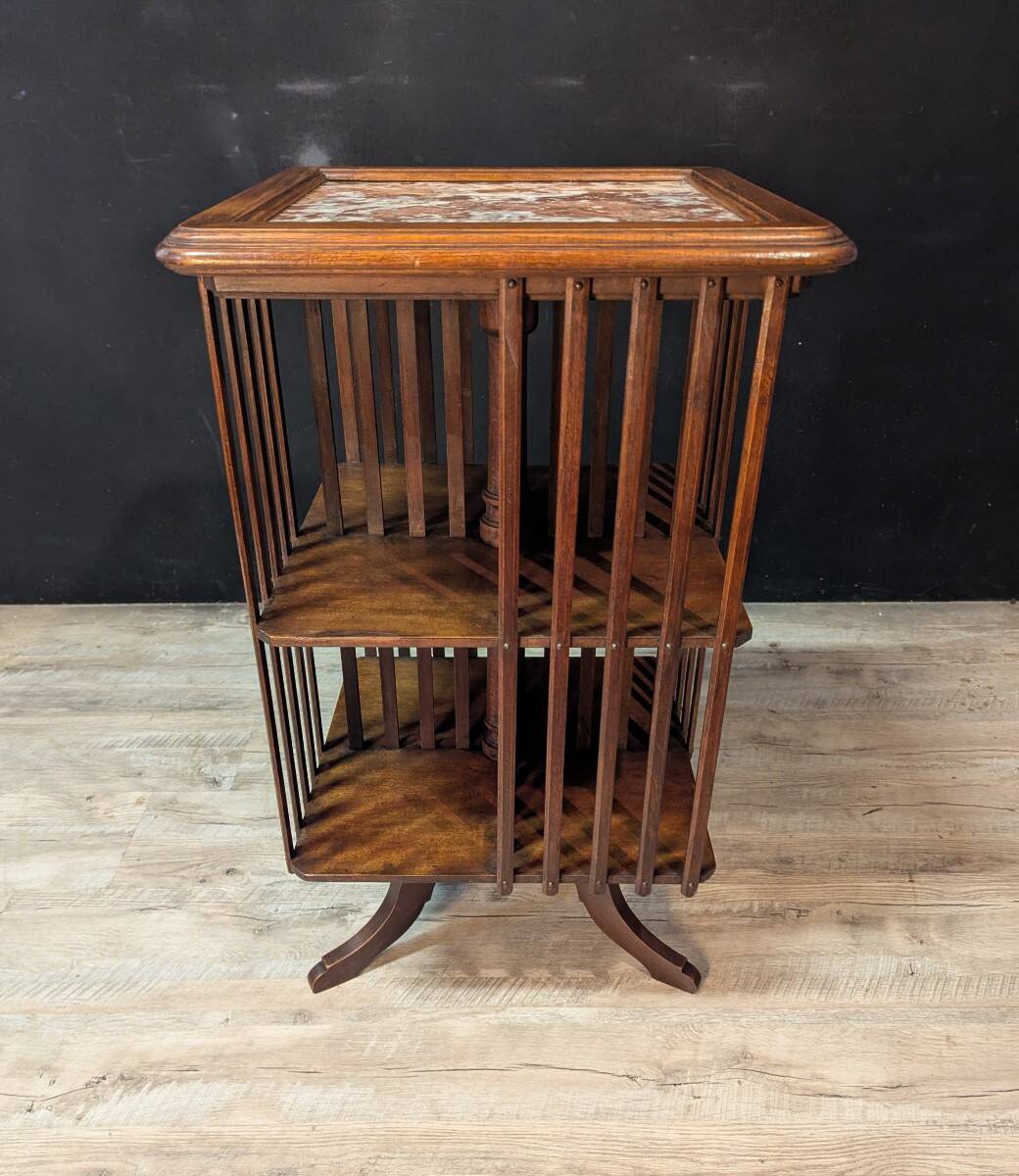 Rotating walnut library with a marble top.