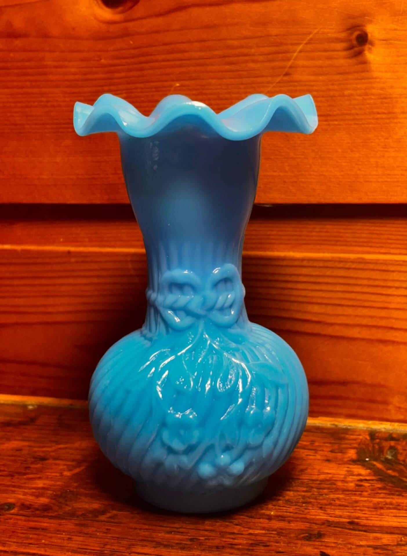 Blue opaline vase, opaque glass, wavy neck/rim, relief decoration of a bow.