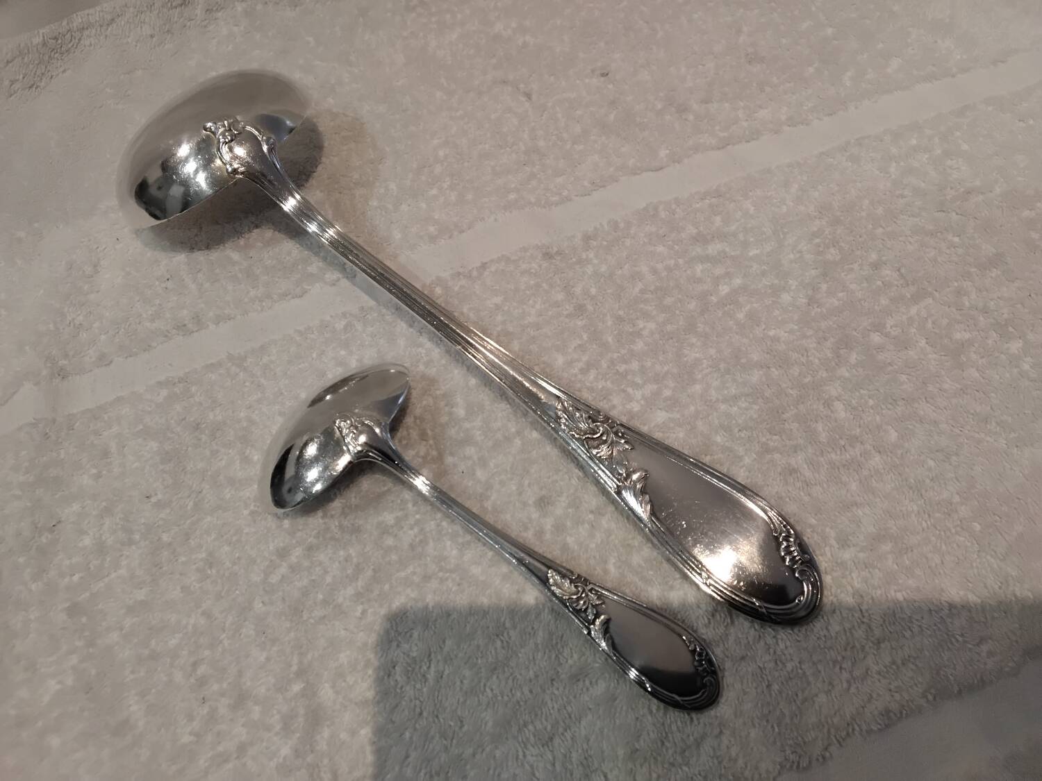 2 Silver-plated soup and sauce ladles with rocaille ribbon decoration