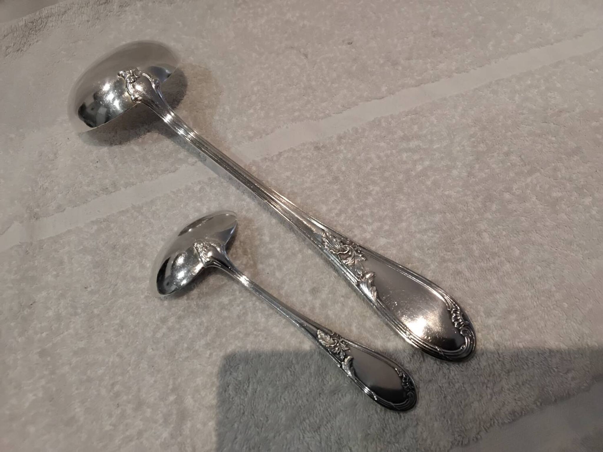 2 Silver-plated soup and sauce ladles with rocaille ribbon decoration