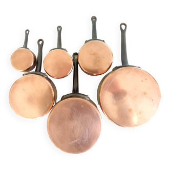 Set of six copper pans with cast iron handles