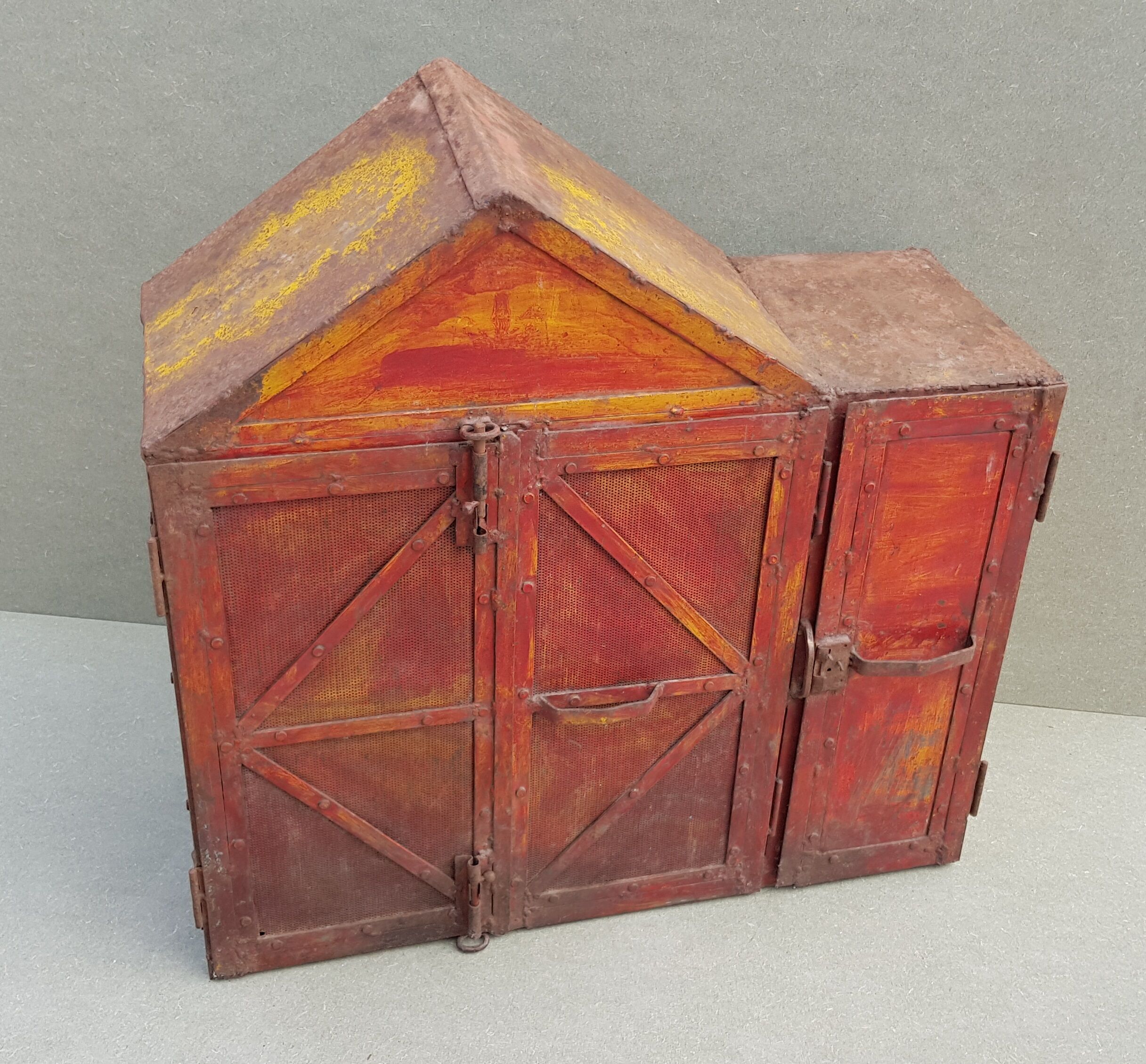 Old atypical metal workshop furniture with its original red patina