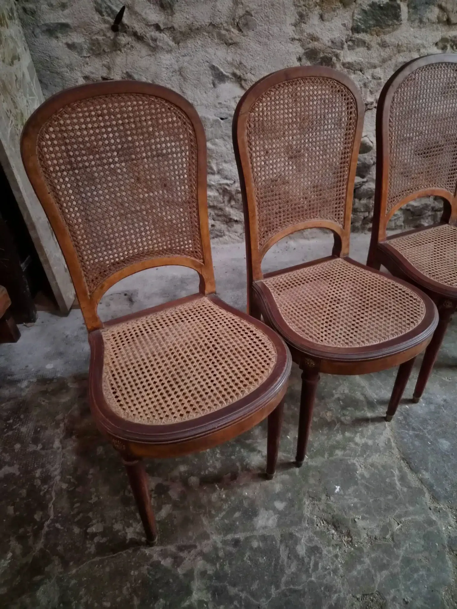 Set of 6 antique Louis XVI style dining chairs with caning.