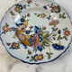 Flat plate in earthenware with polychrome decoration in Rouen style