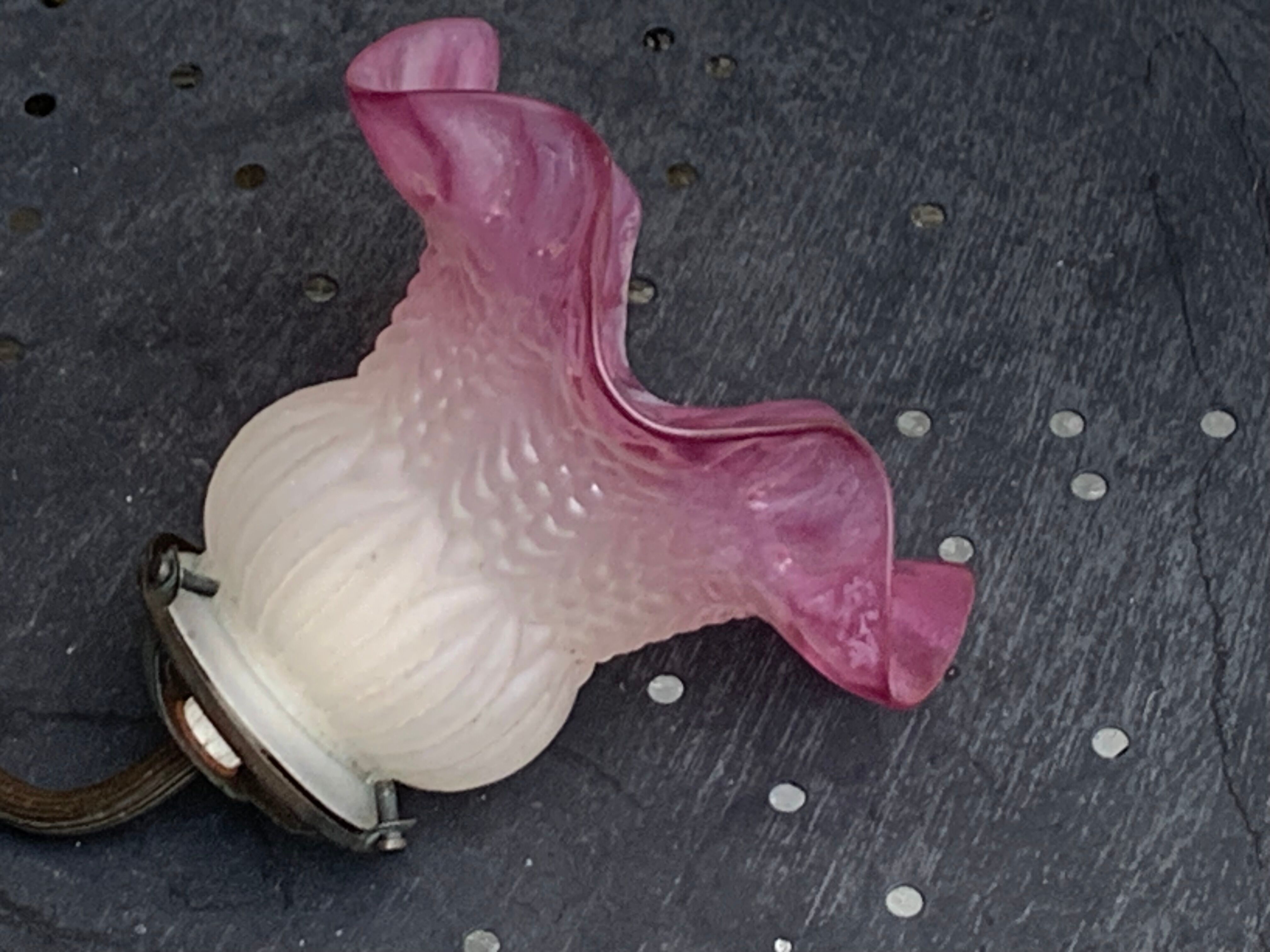 Metal wall lamp with frosted glass shade in the shape of a pink corolla