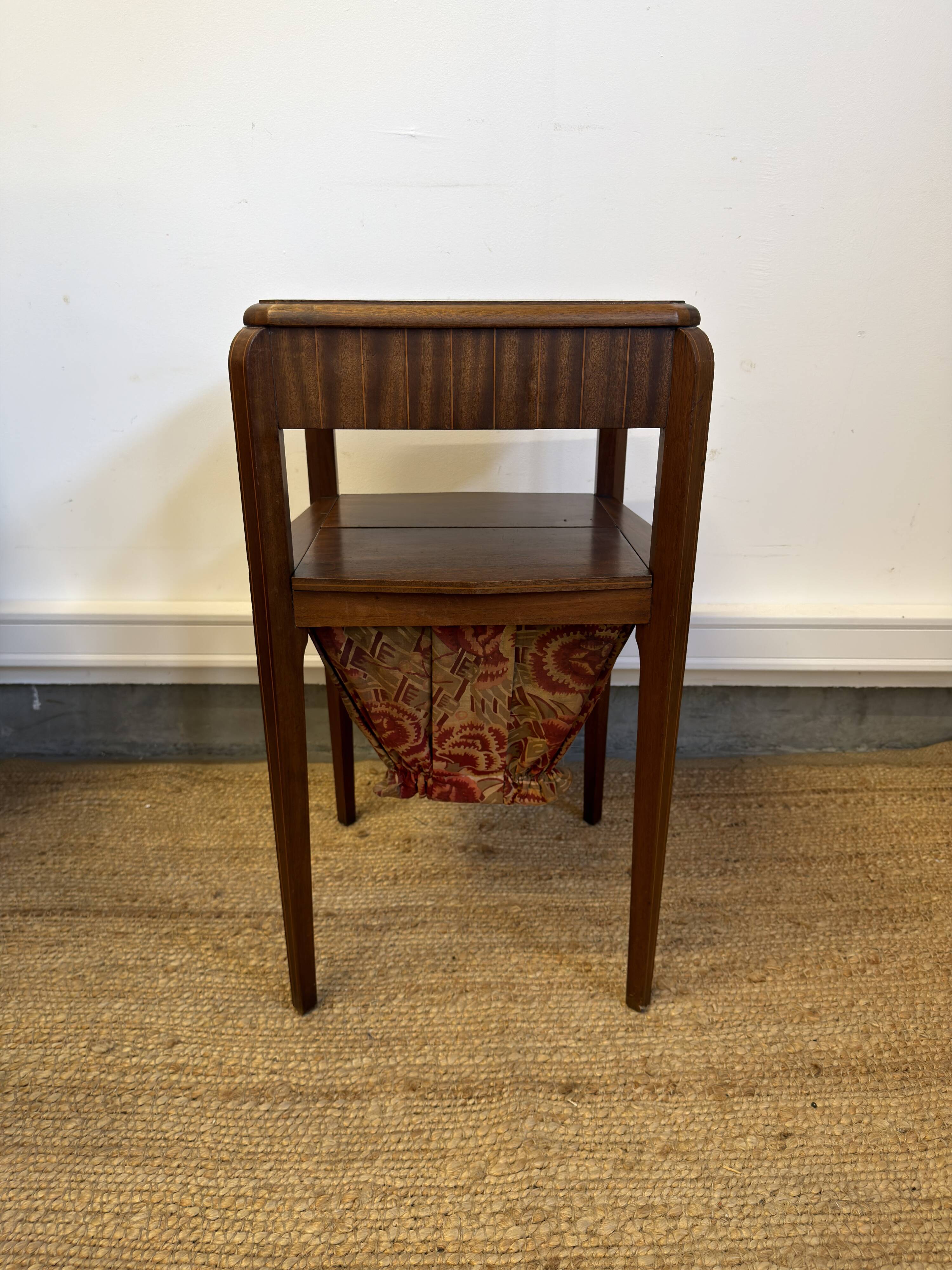 Art Deco sewing table in walnut with a foldable shelf.