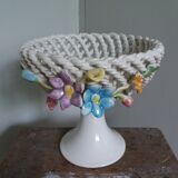 Cup on woven ceramic base with slip flowers
