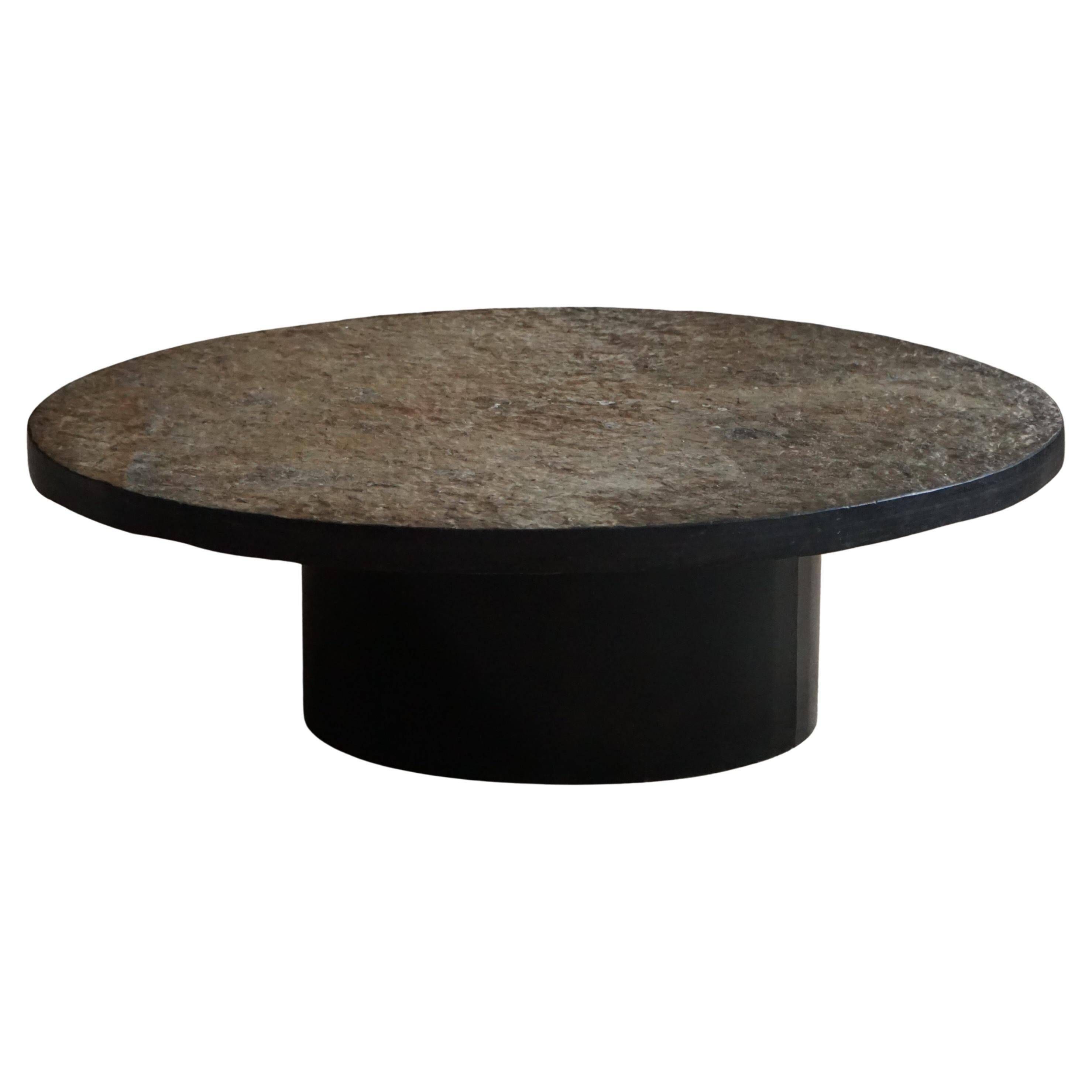 Round brutalist coffee table in stone and steel, mid-century French modernism, 1970s.