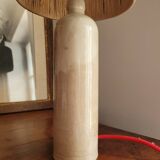 Sandstone lamp with raffia shade