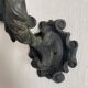 Antique cast iron coat hook with swimmer and shell basin.