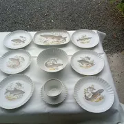 vintage porcelain dinner service with fish pattern and gold trim
