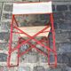 Folding metal armchair