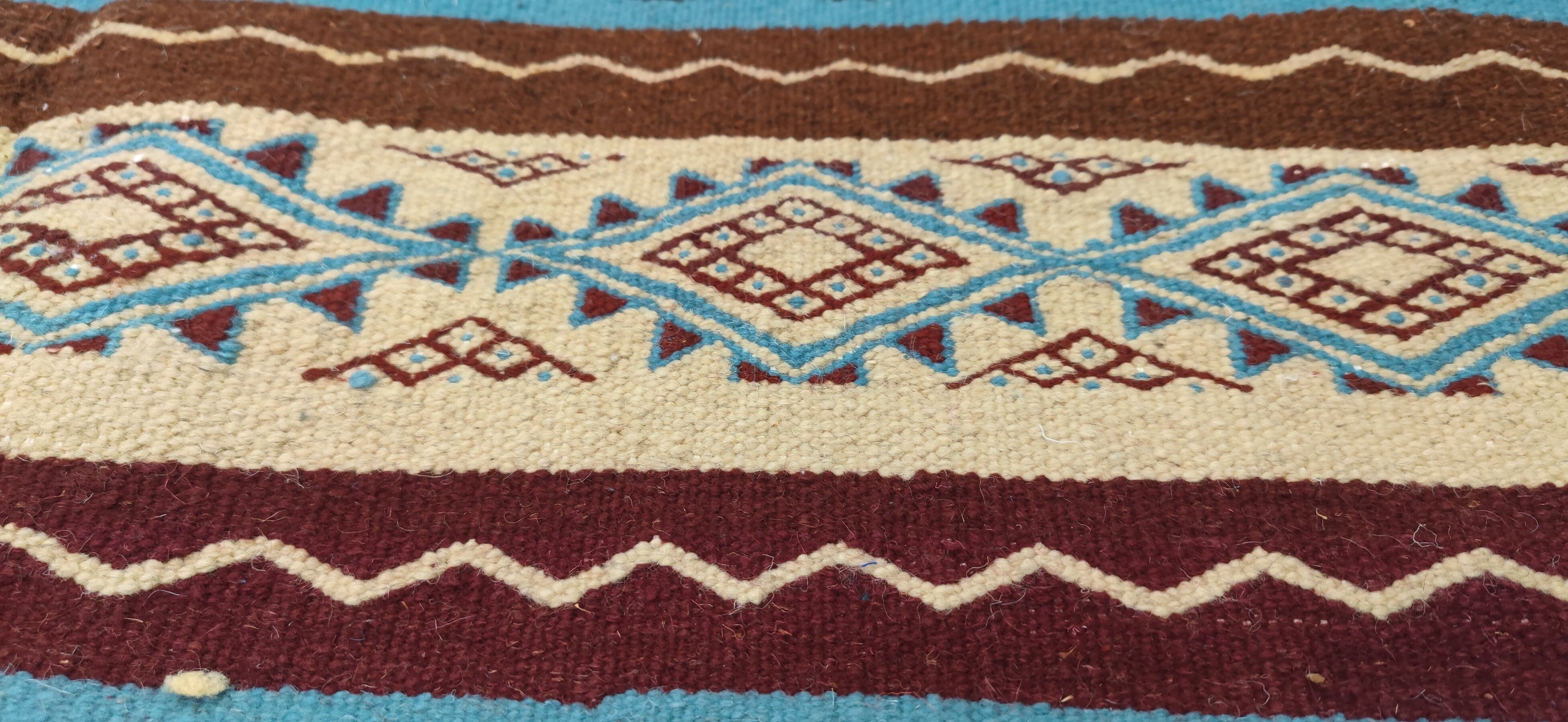 Multicolored hand-woven Berber rugs in natural wool