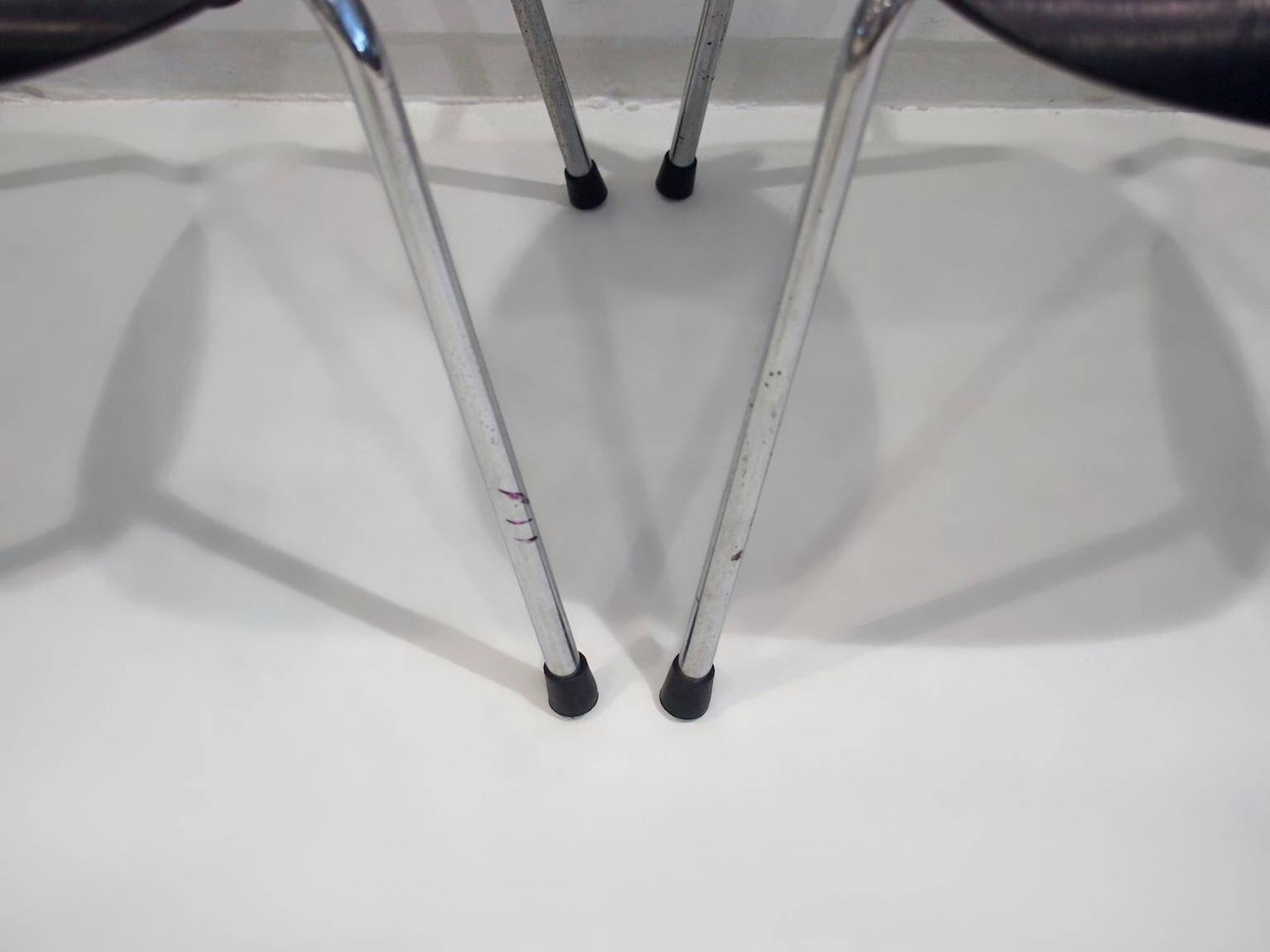 Set of four Egon Eiermann model SE 68 chairs in black lacquered plywood and steel.
