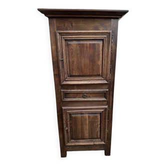 Man - standing - narrow two-door cabinet with a central drawer