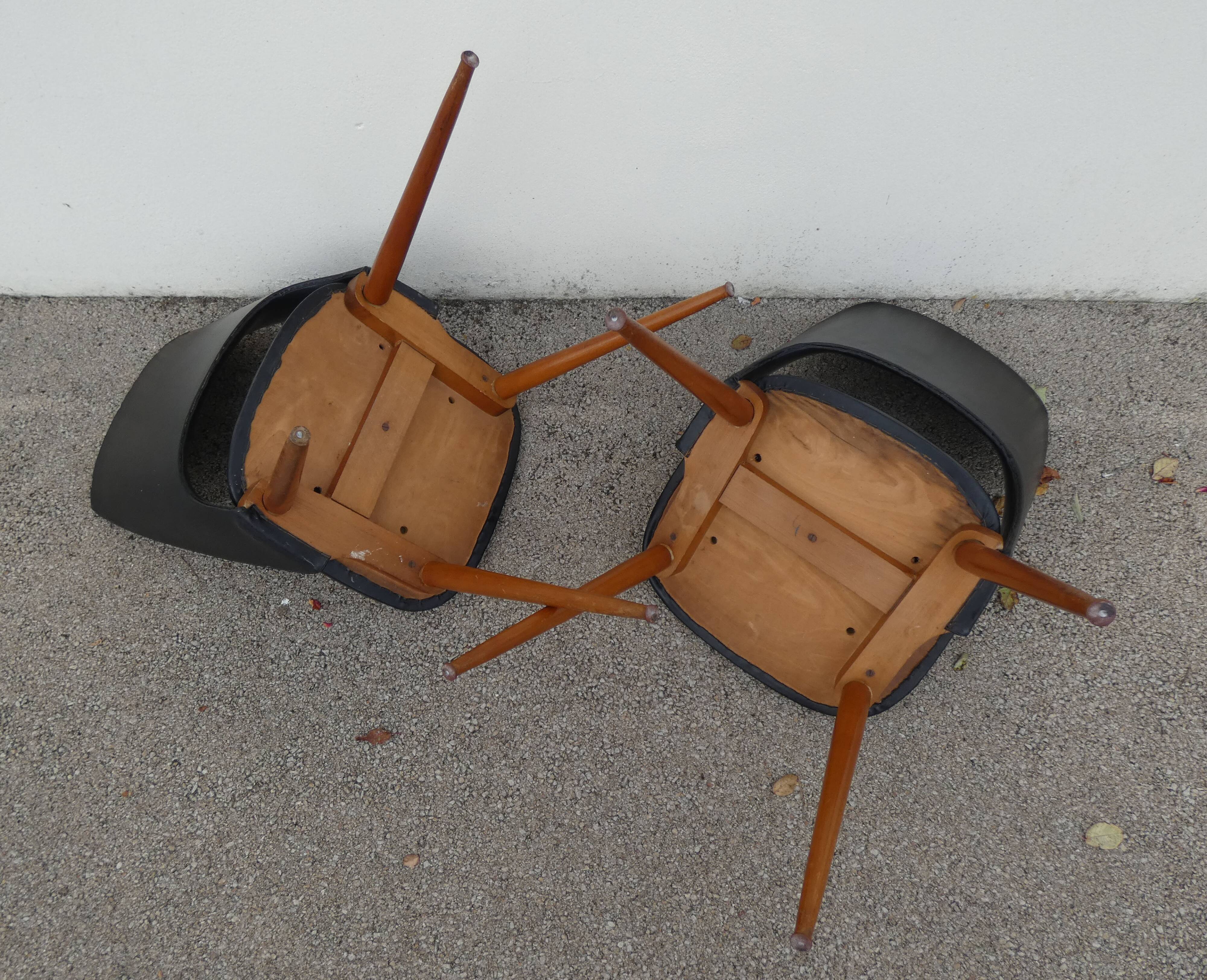 2 chairs in black skai compass legs Louis Paolozzi