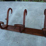 Coat rack with four double curved wooden pads