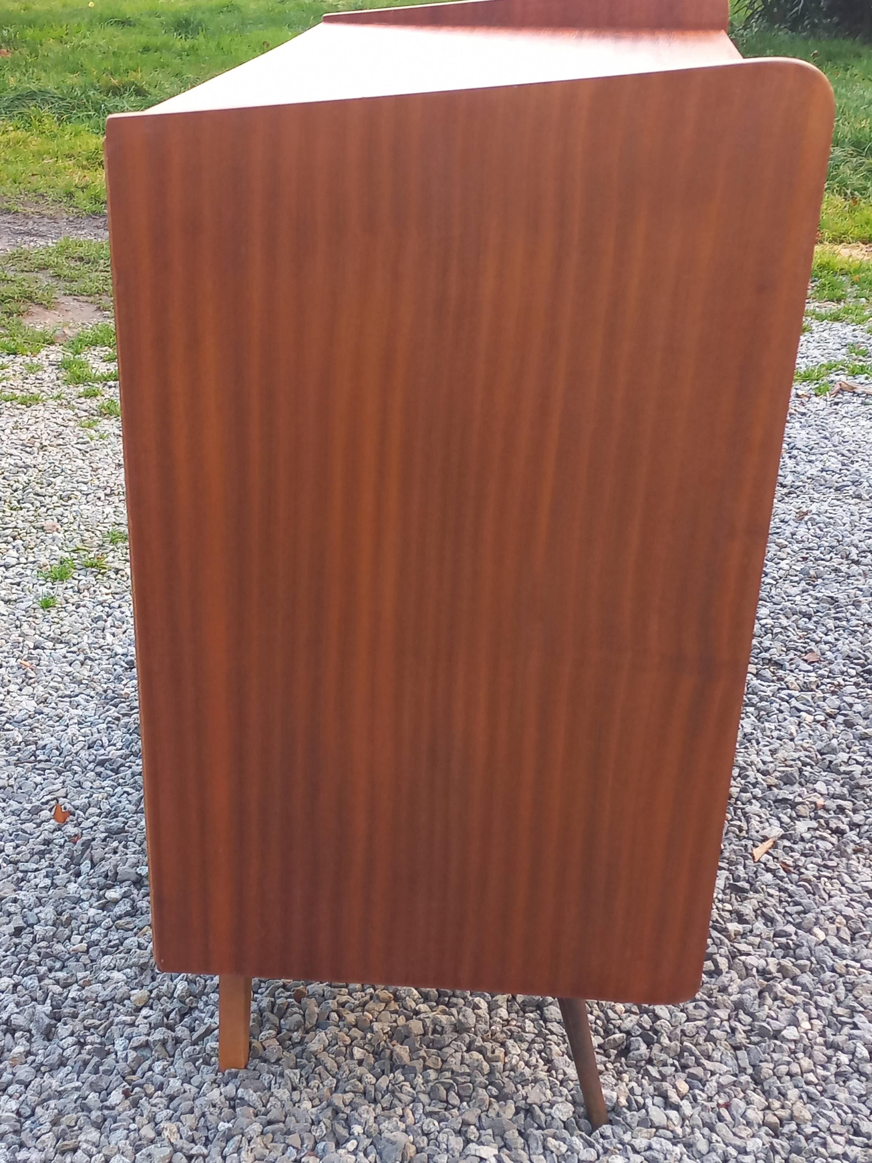 Vintage mahogany commode with metal tapered legs, 4 drawers, 1950s.
