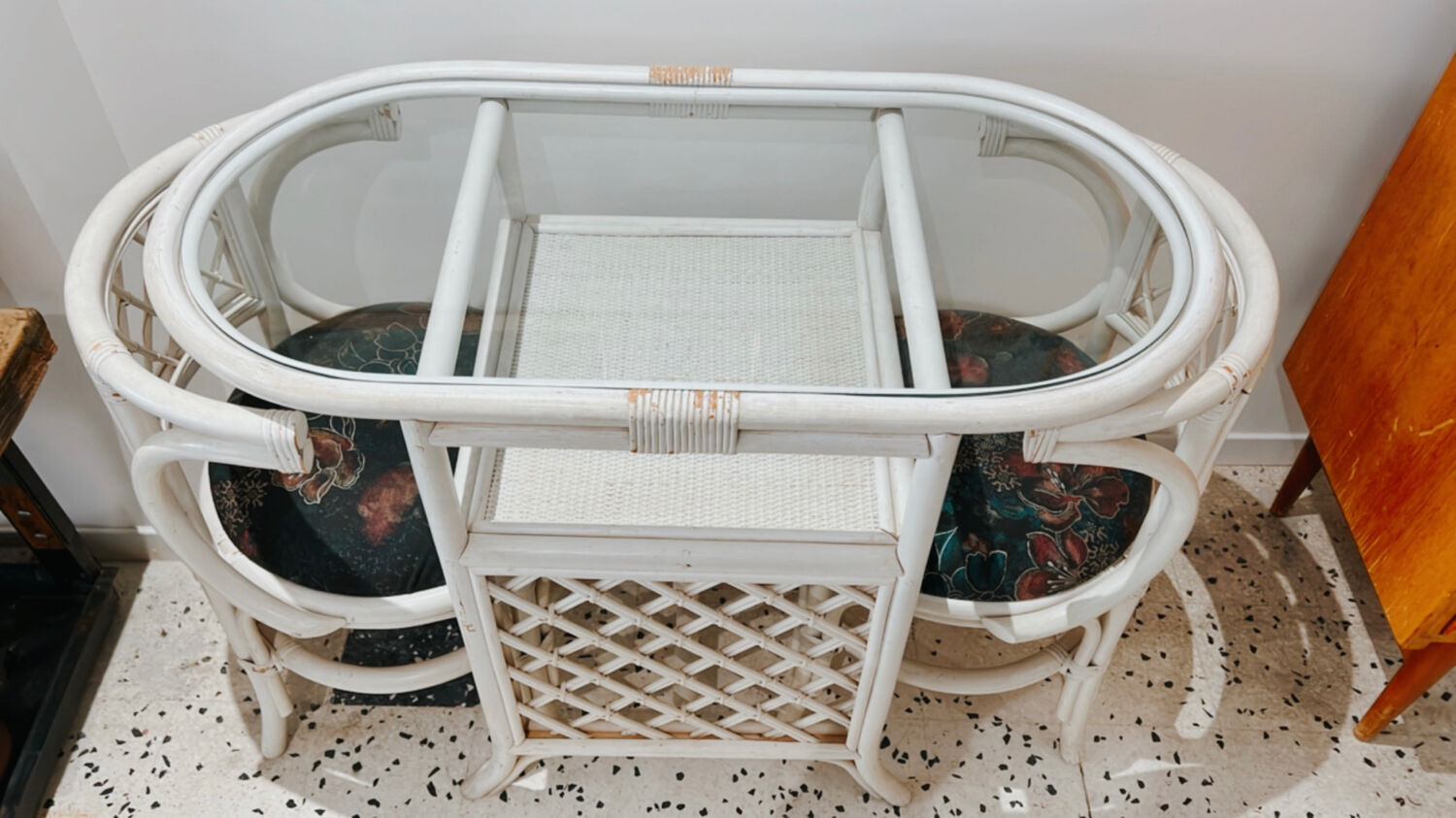 Rattan head-to-head table with vintage armchairs