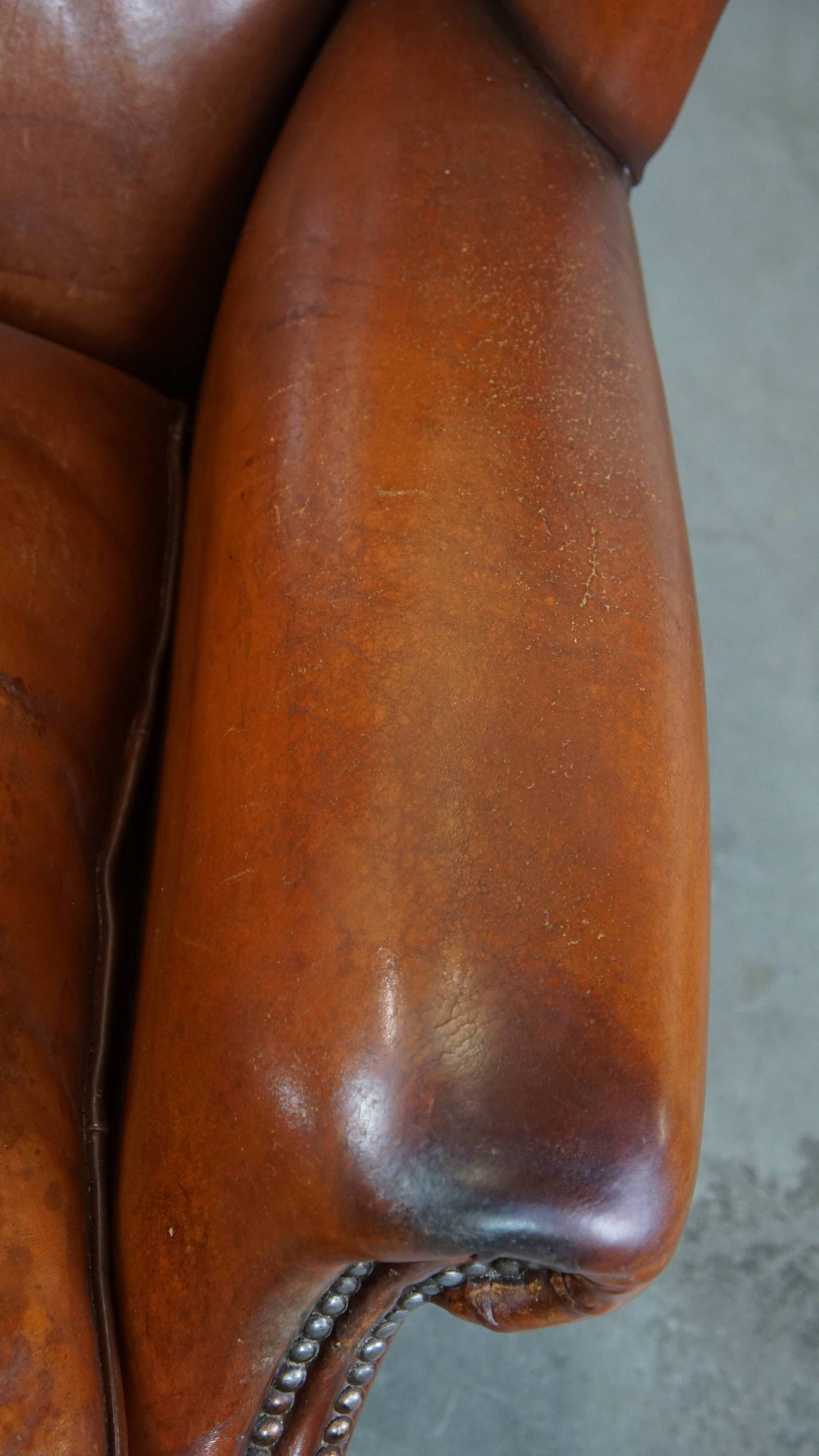 Sheepskin leather wingback chair with patina