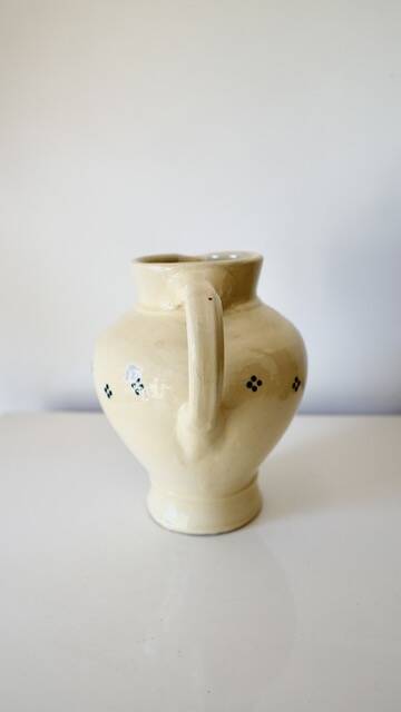 Vintage butter yellow ceramic pitcher in rustic style