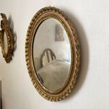 Oval Florentine mirror in powder pink and gold wood, 1960s.