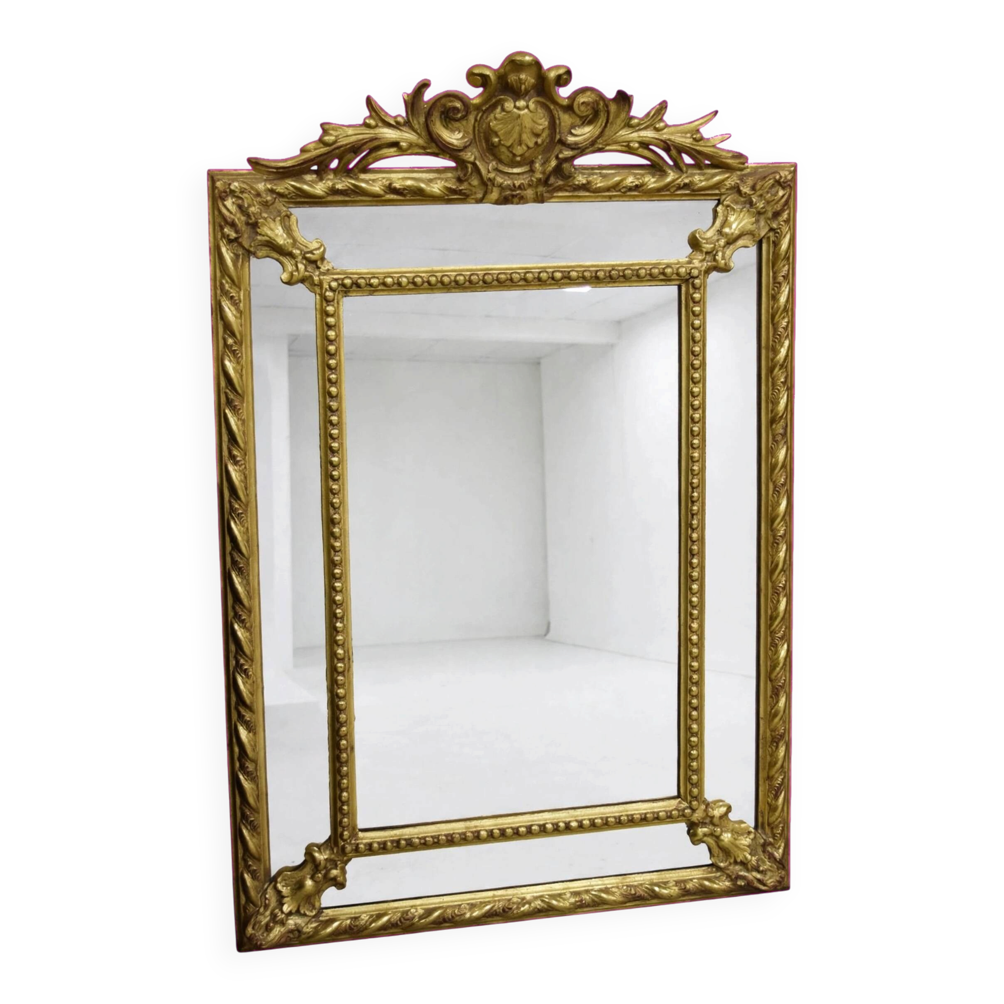 Rectangular glass with a golden frame and a pediment adorned with laurel branches.