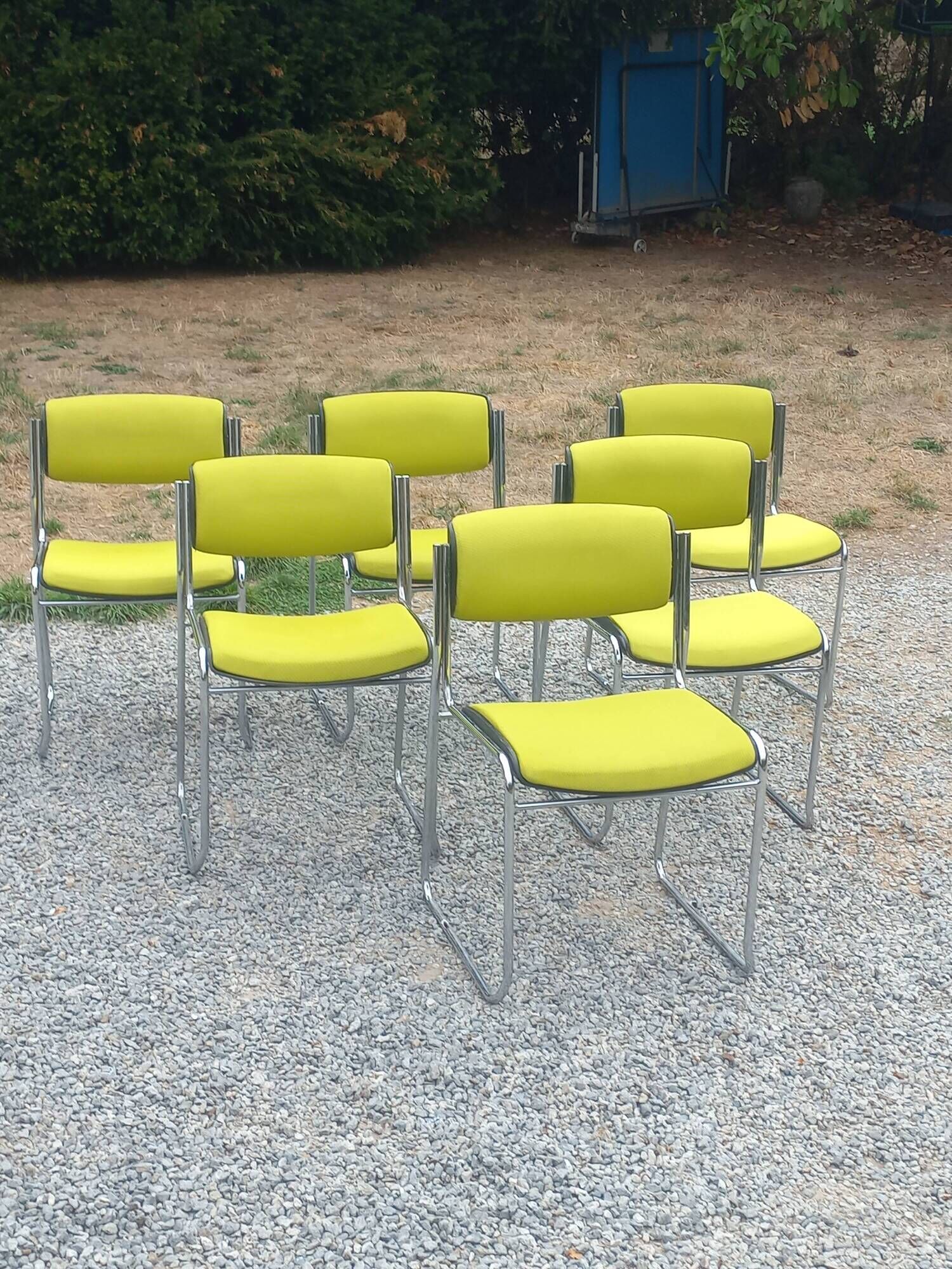 Set of 6 designer chairs with wooden seats and backs, chrome legs.