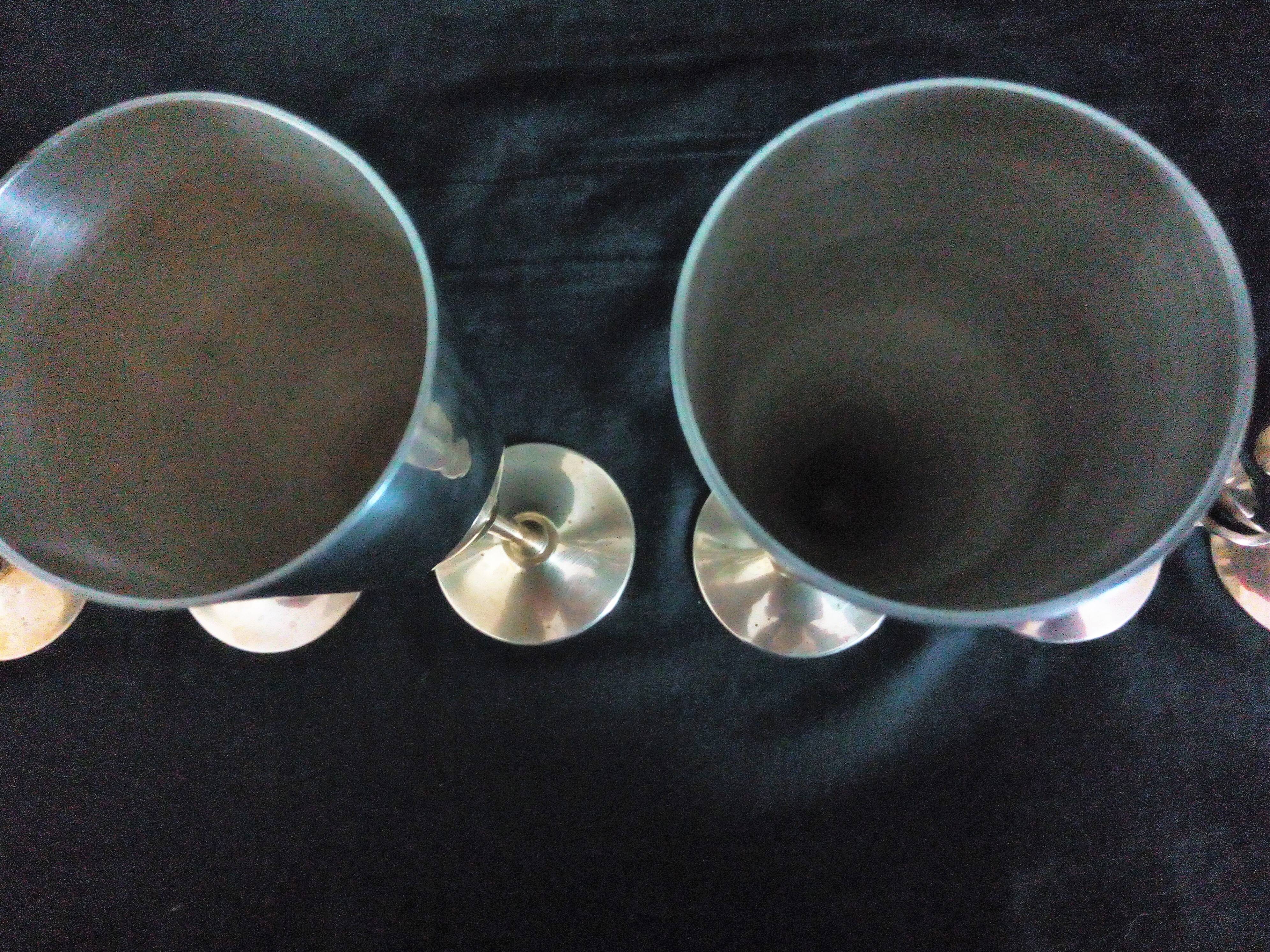 Lot of 12 silver metal flutes on brass stand