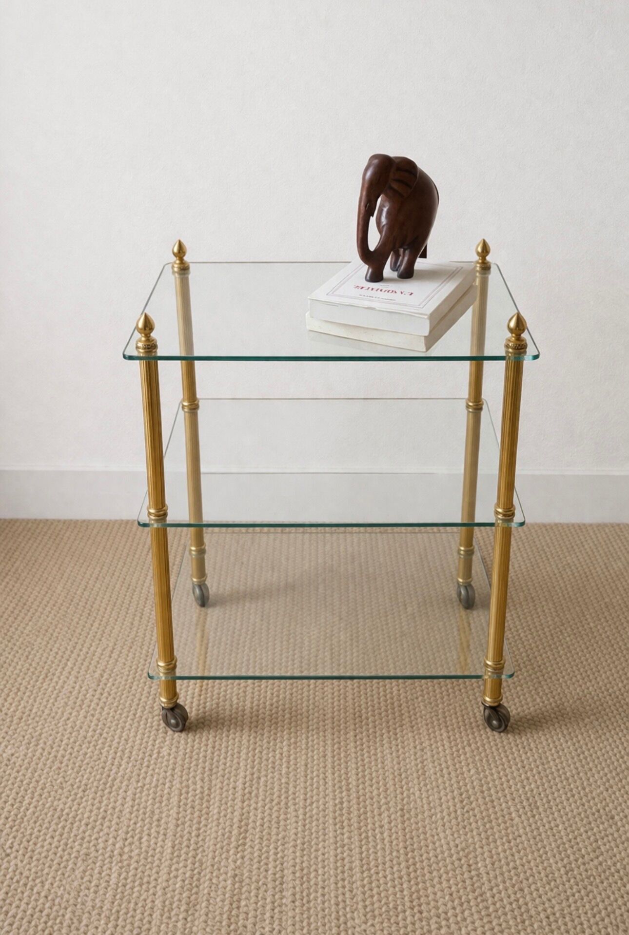 Elegant wheeled serving trolley in gilded brass and glass, in a spirit