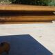 Old walnut table with a central leg.