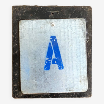 Metal letter A on plaque