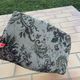 Antique wooden footstool with hand-carved details and floral upholstery –