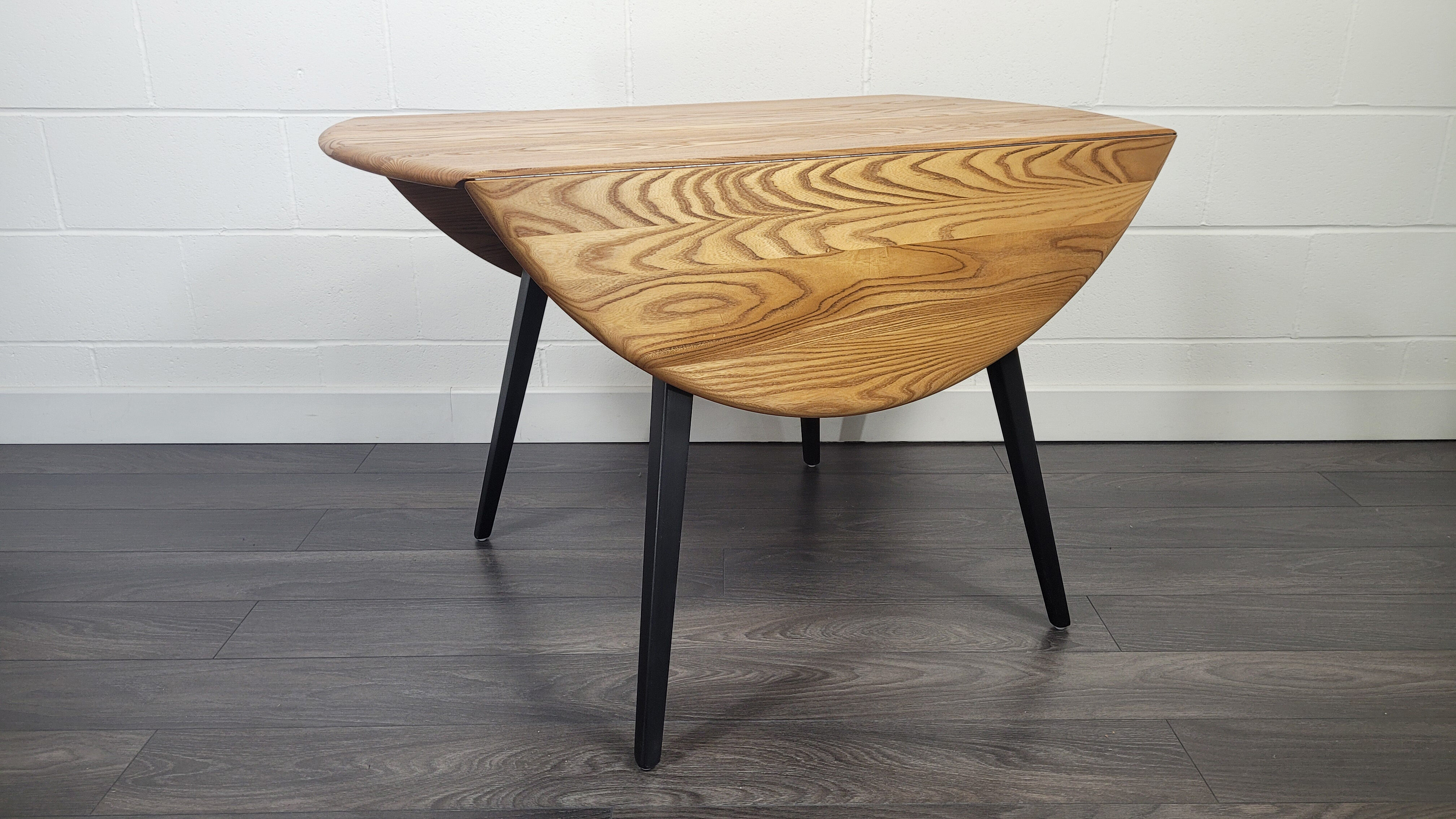 Ercol round drop leaf dining table - black leg, 1960