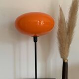 Table lamp with a vintage orange glass globe saucer and a gold base