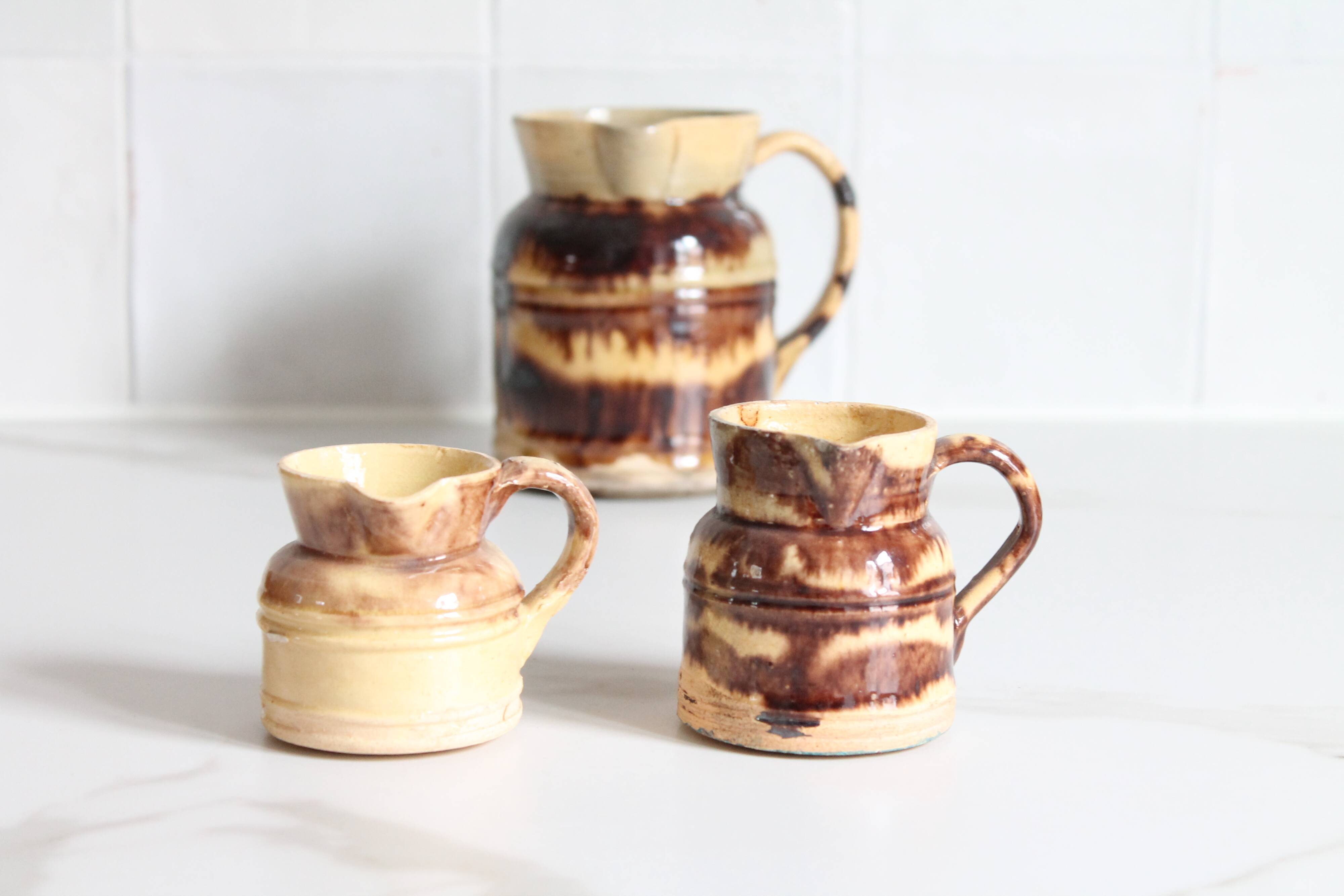 3 old bicoloured enamelled stoneware jugs
