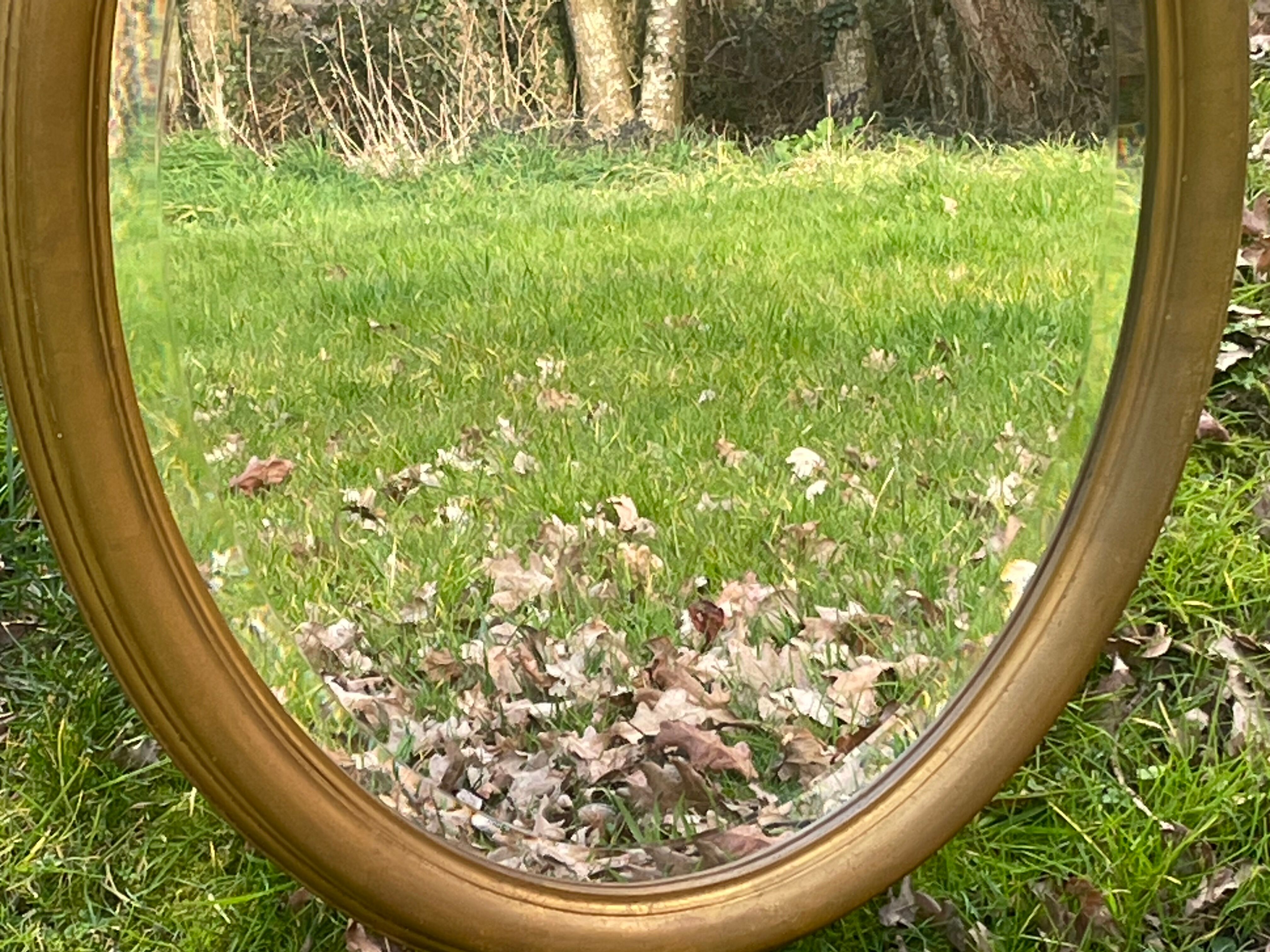 Bevelled golden oval mirror, 79 x 59 cm