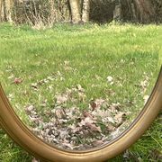 Bevelled golden oval mirror, 79 x 59 cm
